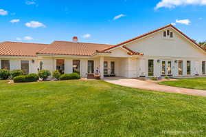 Mediterranean / spanish house with french doors, a patio area, and a front yard