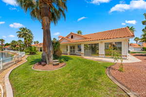 Rear view of property featuring a lawn