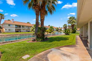 View of yard featuring a balcony and a patio area