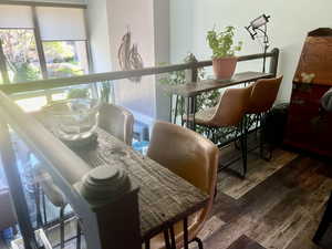 Dining area with hardwood / wood-style floors