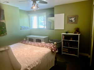 Bedroom featuring dark carpet and ceiling fan