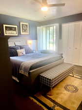 Bedroom featuring carpet, a textured ceiling, and ceiling fan