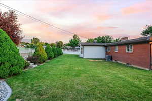 Yard at dusk featuring cooling unit