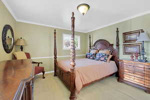 Bedroom with carpet floors and ornamental molding