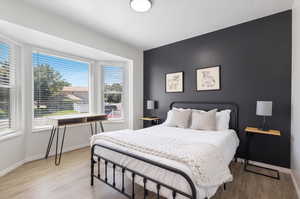 Bedroom with wood-type flooring and multiple windows