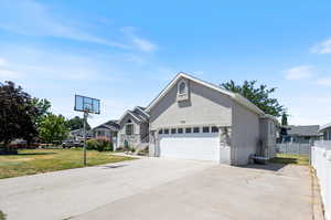 View of front of house with a garage and a front yard