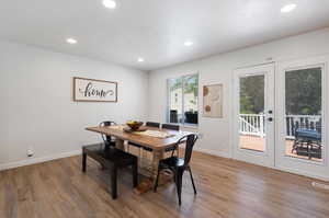 Dining room with french doors and wood-type flooring