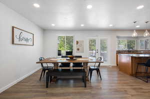 Dining space with hardwood / wood-style flooring, french doors, sink, and a textured ceiling