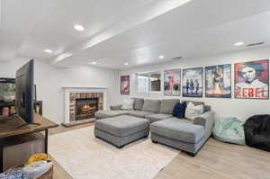 Living room featuring light hardwood / wood-style floors and a fireplace