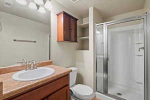 Bathroom with walk in shower, toilet, and vanity