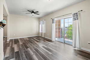 Unfurnished living room featuring hardwood / wood-style flooring and ceiling fan