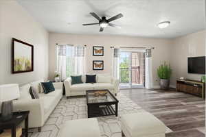 Digitally staged Living room featuring ceiling fan and wood-type flooring