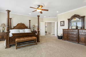 Bedroom with carpet, ceiling fan, and ornamental molding