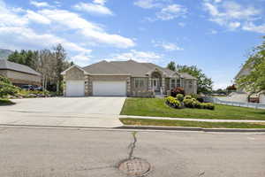 Ranch-style house featuring a garage and a front yard