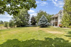 View of yard featuring a balcony