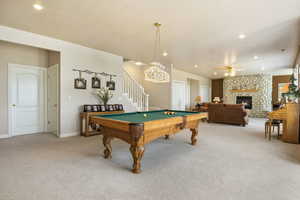 Game room featuring a fireplace, carpet, ceiling fan, and pool table