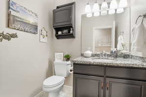 Bathroom featuring vanity, toilet, and tile patterned floors