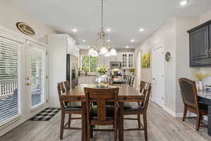 Dining area featuring light hardwood / wood-style floors and a chandelier