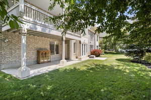 View of yard with a balcony and a patio area