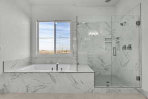 Bathroom featuring separate shower and tub