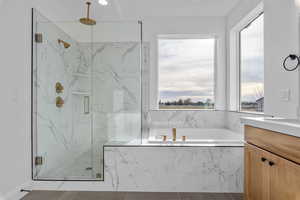 Bathroom featuring separate shower and tub, tile patterned flooring, and vanity