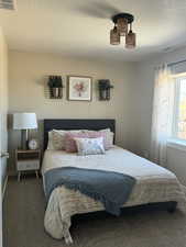 Carpeted bedroom with a textured ceiling