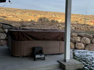 Exterior space with a hot tub and a rural view