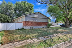 View of side of home with a lawn