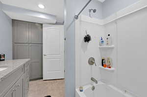 Bathroom with tile patterned floors, vanity, and tub / shower combination