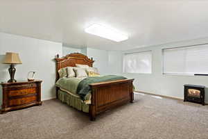 Carpeted bedroom featuring a textured ceiling