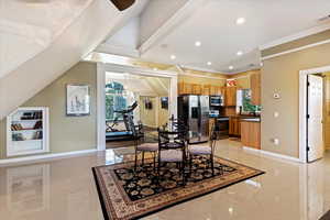 Dining room featuring crown molding, sink, and light tile patterned floors