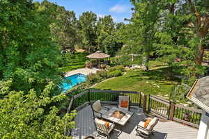 Trex deck featuring a lawn and a gazebo