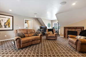 Carpeted living room with a fireplace