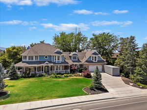 View of front of property with a garage and a front lawn