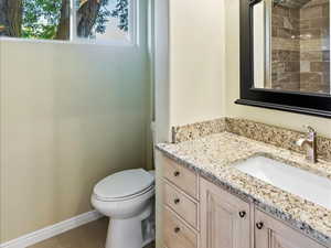 Bathroom with vanity, toilet, tile patterned floors, and ornamental molding