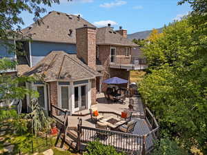 Rear view of house featuring an outdoor living space and a deck