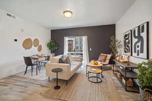 Living room with wood-type flooring