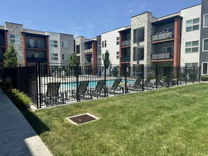 View of swimming pool with a yard