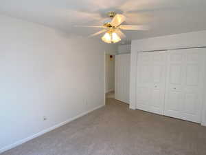 Bedroom featuring a closet, carpet floors, and ceiling fan