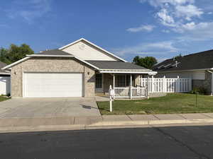 View of front of house featuring a garage and a front yard