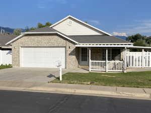 View of front of home with a garage and a front lawn