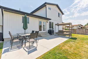 Back of house with a patio, a yard, and french doors