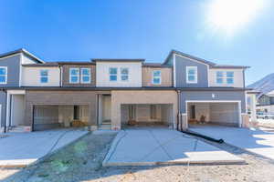 View of front of house with a garage and a mountain view