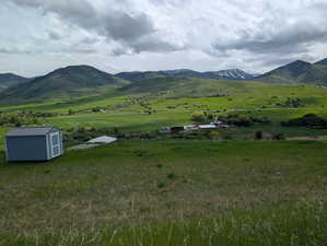 View of mountain backdrop with rural landscape