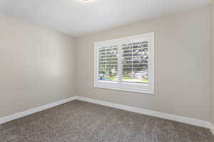 Empty room featuring carpet flooring