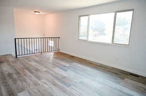 Spare room with hardwood / wood-style floors