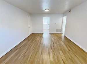 Unfurnished room with light hardwood / wood-style floors