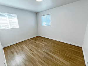 Unfurnished room with hardwood / wood-style flooring