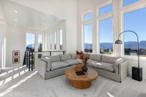 Carpeted living room featuring a mountain view