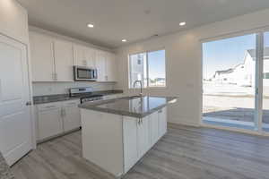 Kitchen and Rear Sliding Door *Photo of similar plan in community, colors and options will vary*